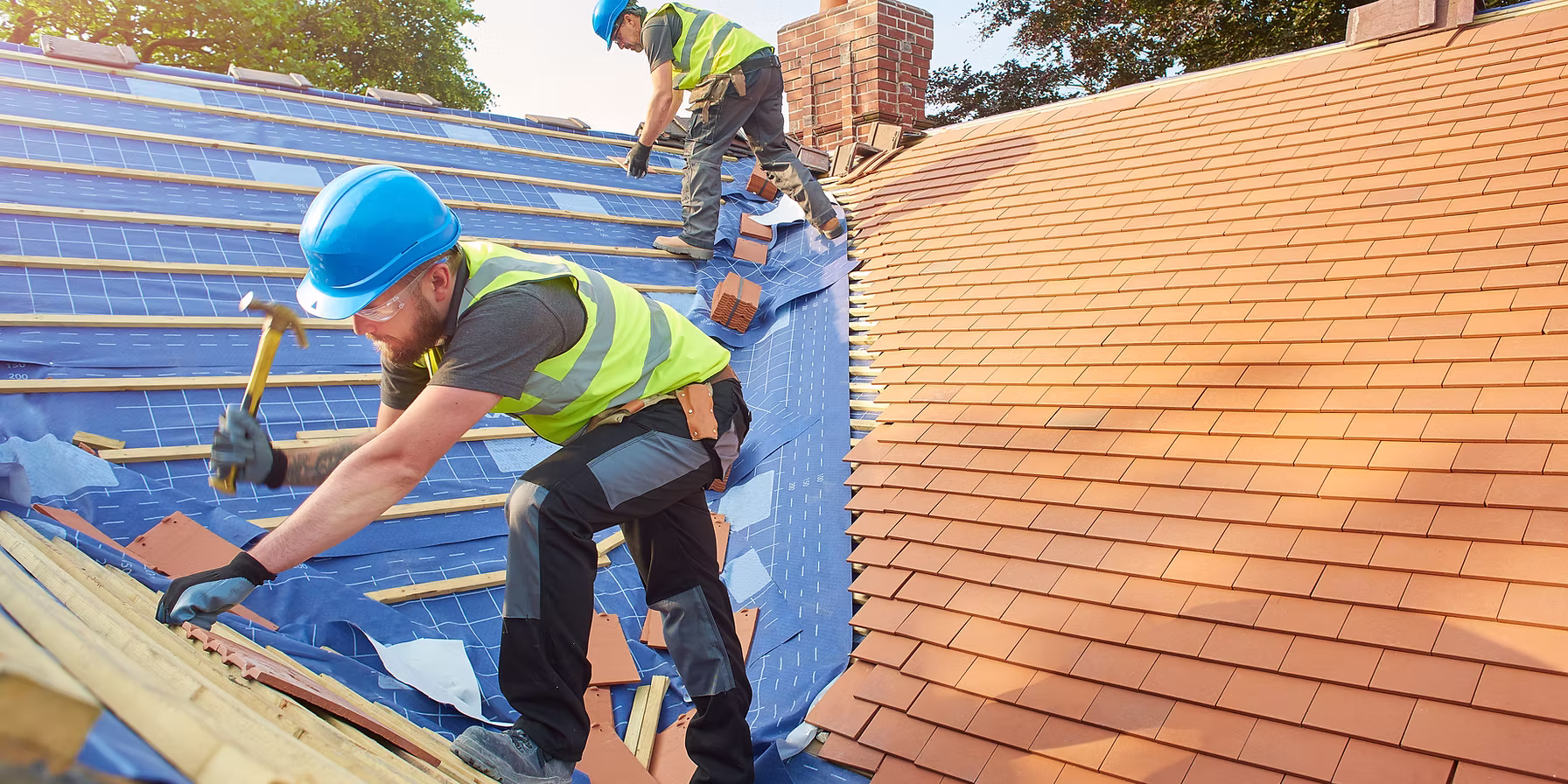 Roofers installing tile roofing after storm damage